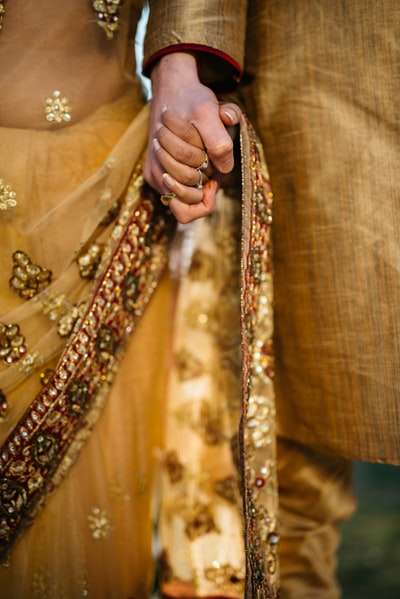 Two people hand in hand in the selective focus
